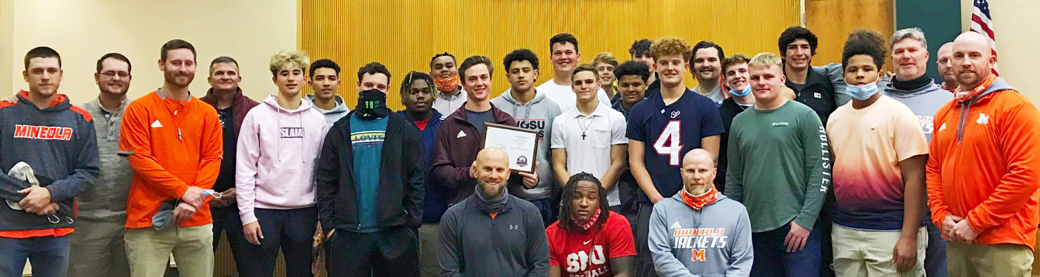 Mineola High School football coaches and players gather at the recent Mineola City Council meeting to be recognized for their accomplishments during the 2020 football season.